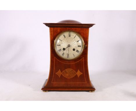 Art Nouveau mahogany and inlaid mantle clock with domed top, silvered guilloche style dial with Roman numerals raised on bun 
