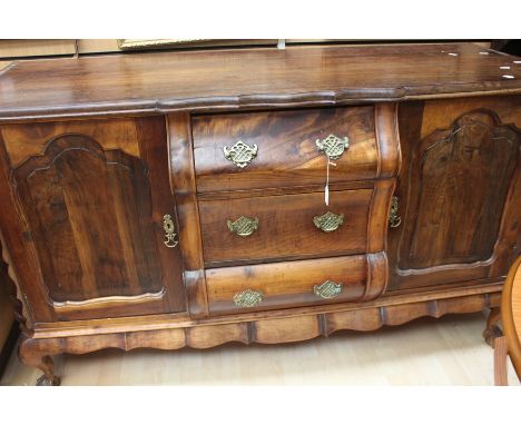 An early 19th century reproduction Dutch Dresser with crow's ball and claw feet and brass ring handles.
