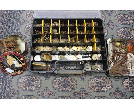 A collection of watch and clock parts and tools.