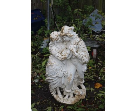 Composite garden statue of a courting couple, painted white