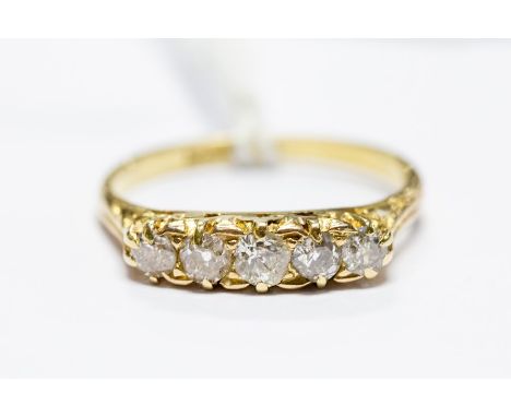 An 18ct gold and diamond five-stone ring, size Q, approx 3gms, in box