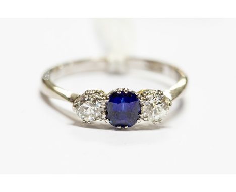 A three stone sapphire and diamond ring, the old cut diamonds approx 0.25ct each, size P, approx 3.4gms, unmarked tests as 18