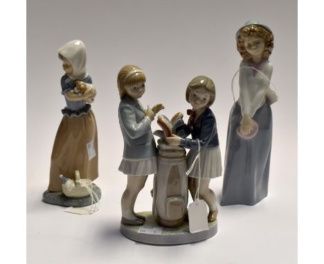 A Lladro figure of two girl golfers along with two Nao figures