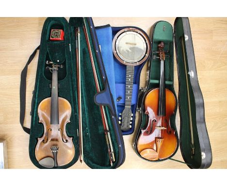 A collection of musical instruments to include; a vintage cased banjo ukulele, Western Samoan banjo, an earlier Fratelli Marc