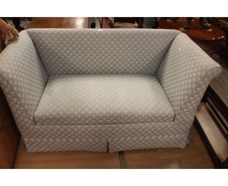 A Modern two seater rectangular sofa, blue upholstery.