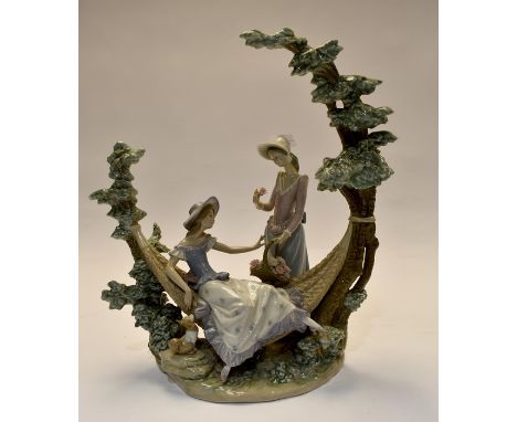 A Lladro figural group of a young girl on a hammock with a flower seller. F-11-SCondition: Damage to back dress sash of flowe