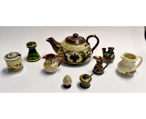 A collection of Devon Ware puzzle jugs and large teapot etc