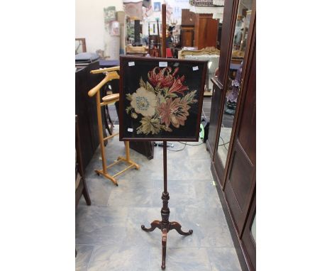 A late 19th century mahogany framed tapestry inlay pole screen on turned supports on a tripod platform on scrolled feet.