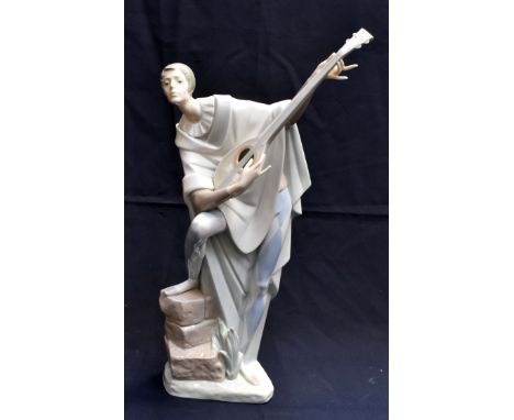 A Lladro figurine in theatrical costume- a male lute player