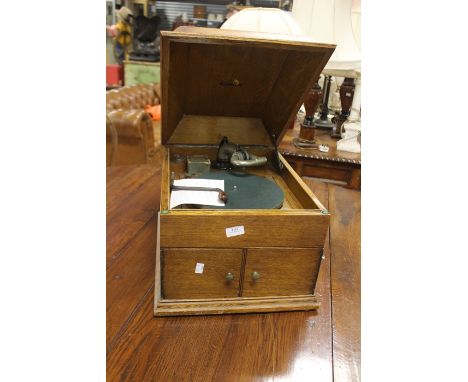 A HMV record player in oak case, reg design number TBO TC08TCM reference number 605812 August 1918, in working order, twin op