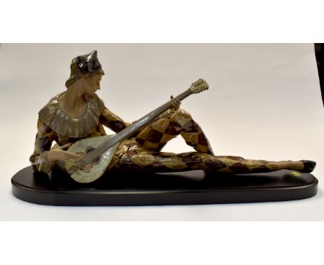 A large Lladro study of "Harlequin" playing a lute. Brown tinted glaze, matt and gloss glazing.