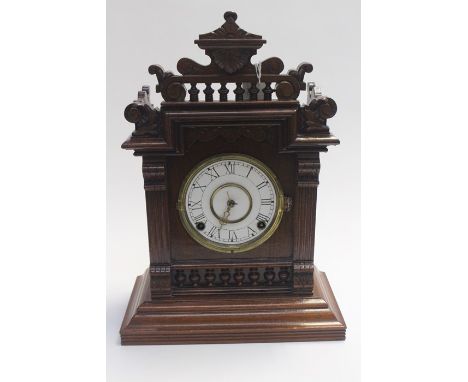 A late Victorian mantle clock with enamel face, key is taped to the top of the clock