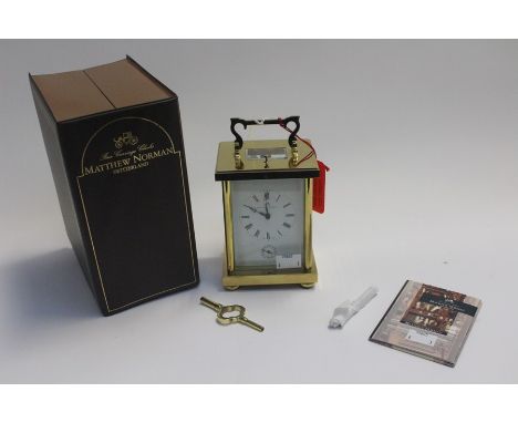 A Carriage Clock by Mathew Norman, complete in original case.
