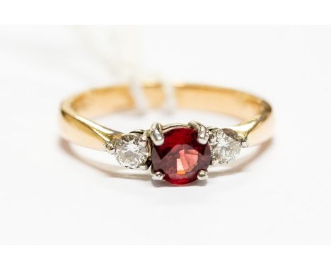 An 18ct gold, red spinel and diamond three stone ring, size P, approx 4.1gms, with certificate&nbsp;