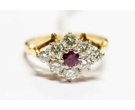 A ruby and diamond cluster ring, the central round-cut ruby surrounded by eight diamonds approx 0.70ct total, ring size M, un