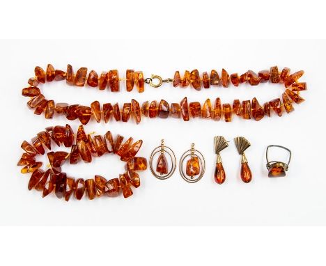 An amber necklace, and another string, a pair of earrings, ring and a pair of amber type earrings, total gross weight approx 