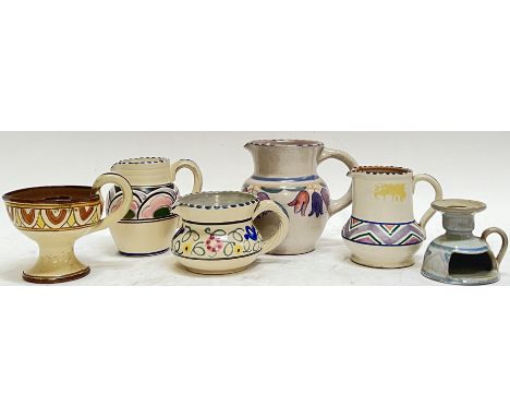 A mixed group of Honiton/Devonshire ceramics decorated in the Poole style, comprising four variously decorated jugs, and two 