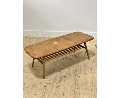 A 1960s Ercol elm topped rectangular low coffee table on light ash splay tapered supports united by slatted under tier top sh