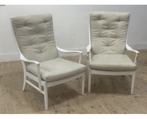 A pair of 1960s white painted Parker Knoll easy chairs with ladder backs with back and seat cushions, on turned supports (h.9