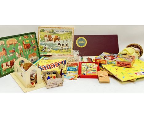 A group of vintage and used children's toys and games including Scrabble, jigsaw puzzles, blocks, board games, Japanese Kokes