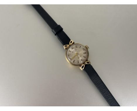 A lady's 9ct gold Rotary wristwatch,&nbsp;with silvered dial and Arabic numbers at the quarters on black leather strap D x 1.