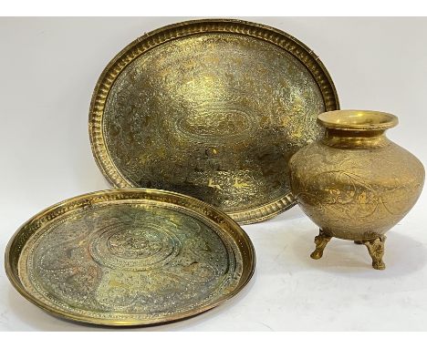 Two Eastern brass trays, probably Indian, decorated with various stylised flora/fauna (largest w- 42cm), together with an Eas