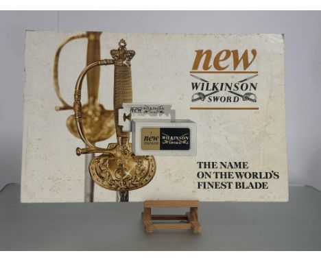 A trio of Vintage Wilkinson Sword Barber Shop Advertising signs one for - The New 5 Stainless Blade (47.5cmx73cm) the other t