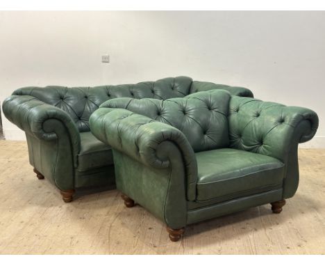 A modern two piece lounge suite composed of a Chesterfield sofa with scroll button arms and back, with two loose seat cushion