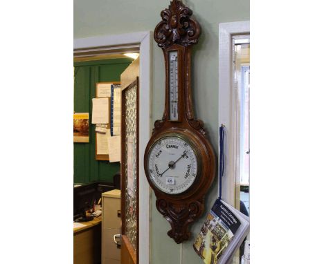 Carved oak barometer-thermometer, the dial signed T.L. Ainsley, Cardiff, Barry &amp; Newport
