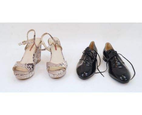 Prada: a pair of black patent leather lace up shoes, size '38.5', with gilded logo to insole and leather stamps to heel, in o