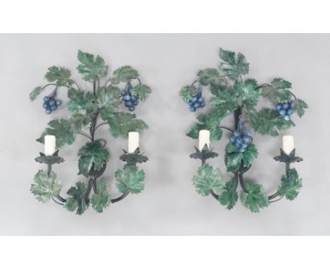 A pair of painted metal two light wall lights, circa 1970, in the form of grape vines with grapes, each 48cm high (2) It is t