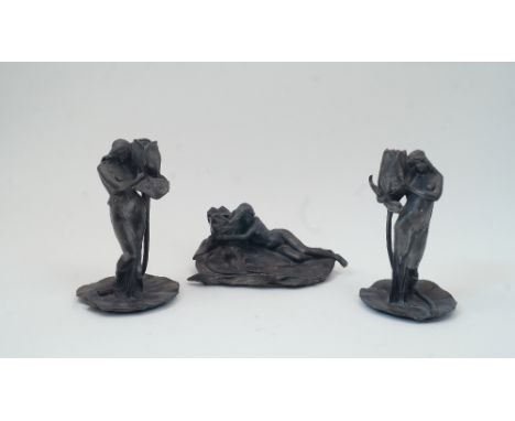 After Alexandre Clerget, French, 1865-1931, two pewter figural candlesticks, each modelled as a half-nude maiden holding an o