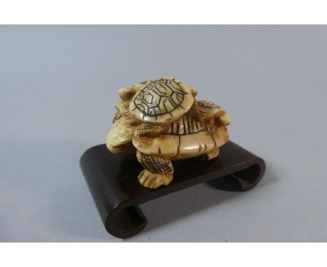 A Signed Chinese Bone Netsuke in the form of Female Tortoise with Young to Her Back 