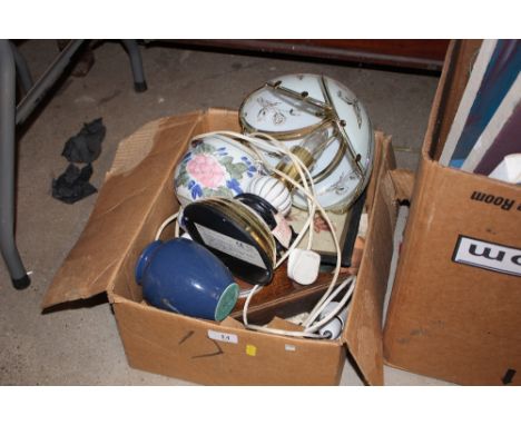 A box containing a table lamp; an oak cased clock etc.