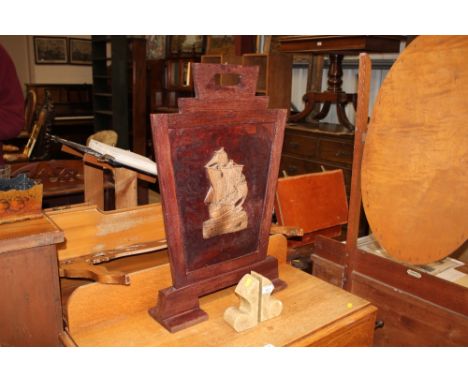 A firescreen decorated with a ship; and a pair of book ends