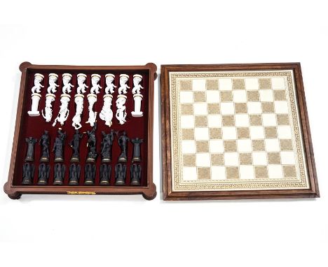 A chess set designed by Stuart Mark Feldman with bisque figures 'Of The Gods' in case with chess board top