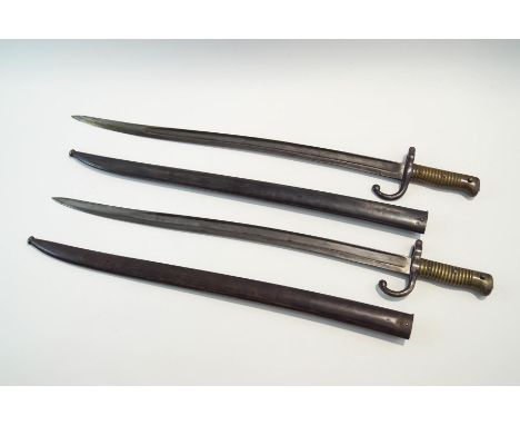 Two French bayonets, both with inscriptions to the blades, one stamped R.42280, the other S.51739 and the scabbard M.43029