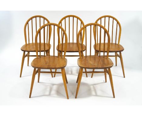 An Ercol drop leaf elm and beech table and five stick back chairs