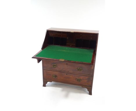 A Georgian III mahogany bureau, the fall front enclosing a pigeon hole interior and seven drawers, over three long drawers up