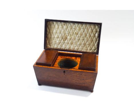 A Regency walnut tea caddy of sarcophagus form, on bun feet