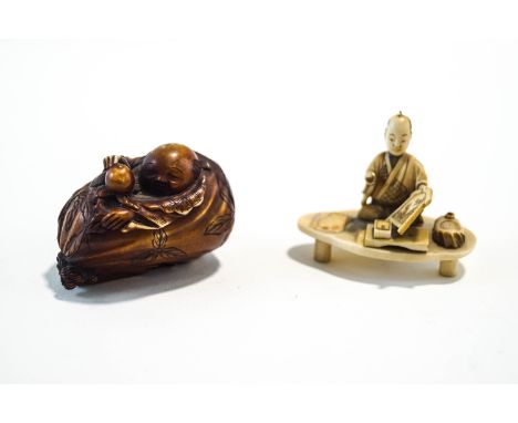 A Japanese Ivory carved figure of an artist, signed,  and a Japanese carved and stained netsuke