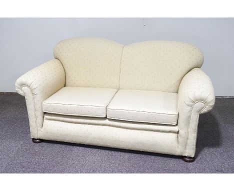 An early 20th century drop end sofa, upholstered in patterned cream fabric, 164cm long