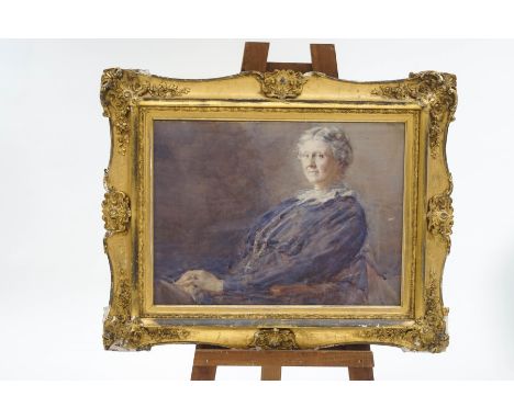 A late 19th/early 20th century portrait of a seated lady, watercolour,70cm x 51cm, in an ornate giltwood frame