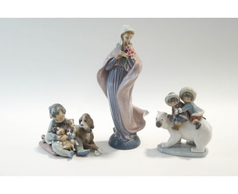 Three Lladro figures : Two Inuit children on a polar bear, Child with dog and puppies, and a robed lady