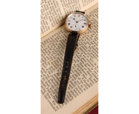 A 9ct gold trench wristwatch, 31mm diameter case, white enamel dial, black Roman numerals with red 12 o'clock, subsidiary sec