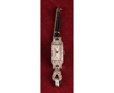 An early 20th century platinum and diamond cocktail watch, canted rectangular platinum case and strap shoulders pave set with