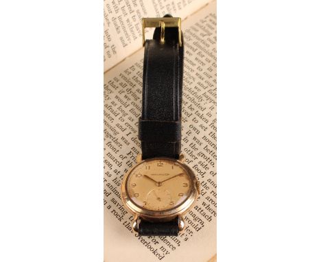 Jaeger Le Coultre - a 1950s 9ct gold cased wristwatch, salmon dial, raised Arabic numerals, subsidiary seconds, manual stem w