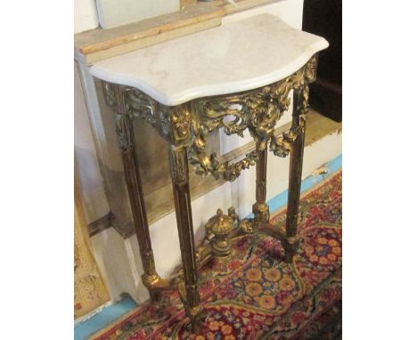 CONSOLE TABLE, Continental style gilt effect with a serpentine shaped marble top and swags decorated with flowerheads on flut