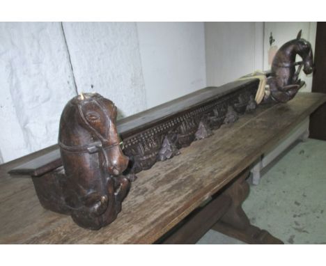 INDIAN SHELF, carved hardwood flanked by horse heads, 123cm x 34cm. (with faults)