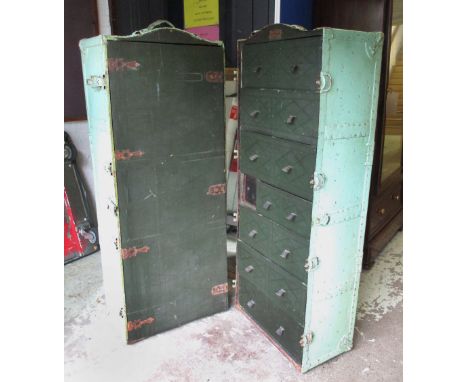 TRAVELLING TRUNK, early 20th century American, green painted containing interior hanging space, seven drawers and a safe, lab